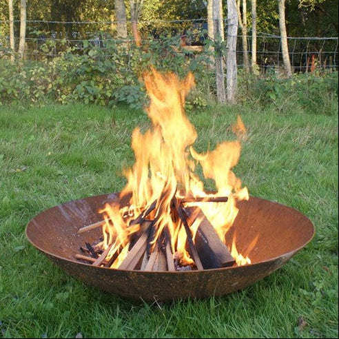 Corten steel curved fire pit with flames