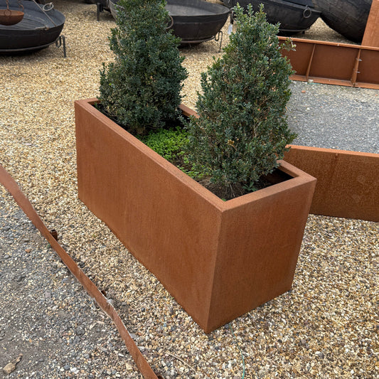 Corten steel trough planter showing weathered rust patina