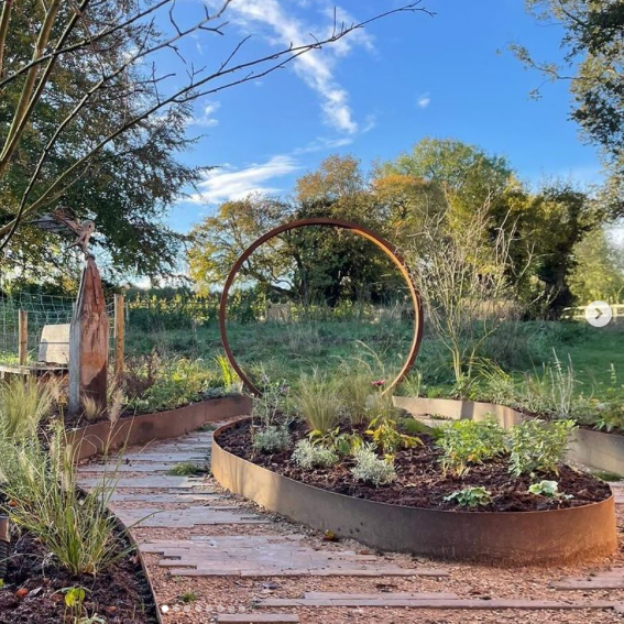 Garden with circular corten metal feature moongate